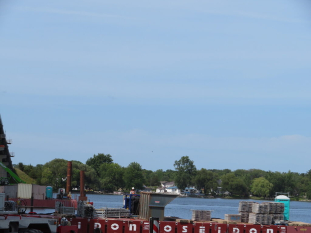 Using the barge to bring the full containment bin to the dock to be emptied