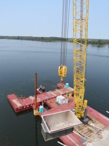 Top view of the full containment bin being lowered by the 200-ton crane