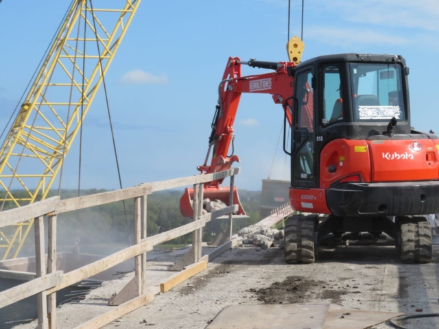 Using the bucket to move the concrete rubble