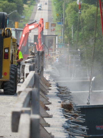 South view of both containment bins being held by the 110 and 200 ton cranes