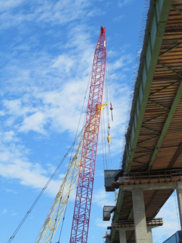 110 and 200 ton cranes lifting containment bins