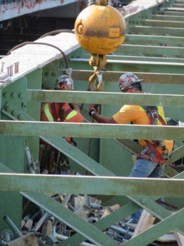 Using the 200-ton crane to pull the anchor cables through the girders