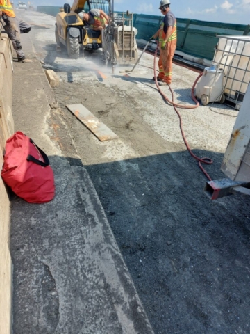 Cutting the concrete deck, to access for containment installation