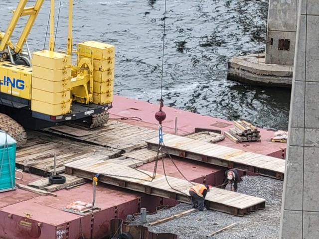 Moving the ramps into place in order to remove the crane from the barge