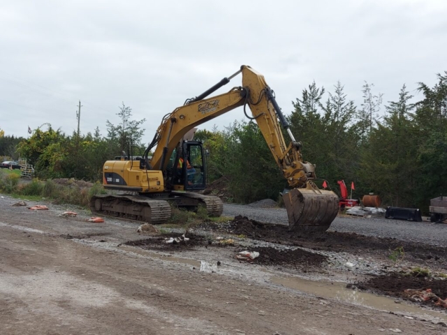 Excavator being used to expand the project site for work access