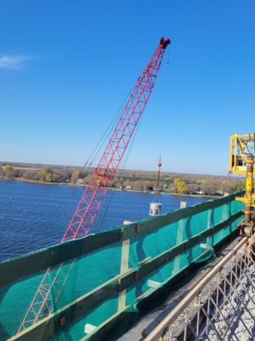 110-ton crane lifting the concrete hopper to the bridge deck