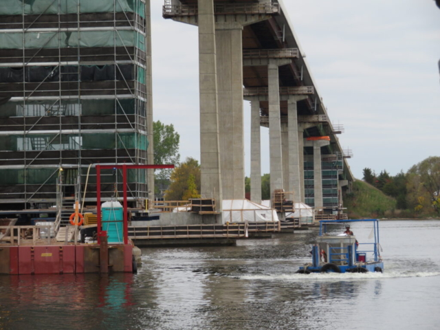 Boat taking the hopper of concrete to pier 10 for placement