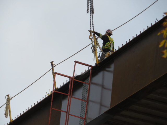 Lowering the straps on the crane in preparation for ladder removal