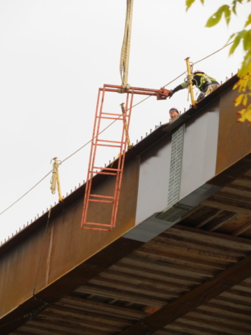 Removing the temporary ladders from the girders