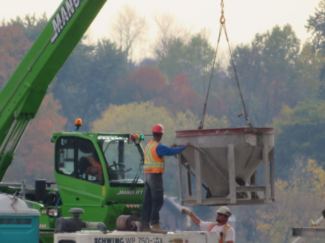 Lowering the hopper to the concrete pump at pier 3 for concrete placement