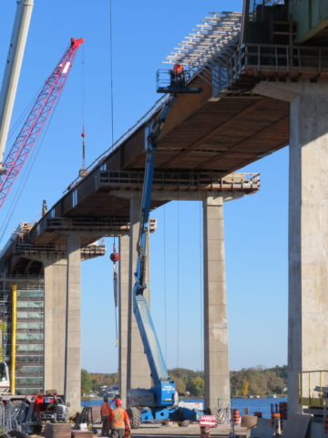 Genie boom being used to install work platform brackets