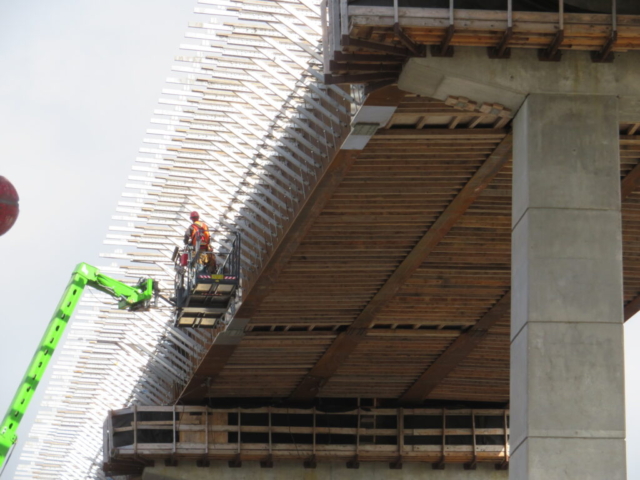 View from below of work platform bracket installation