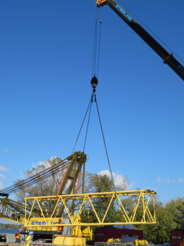 150-ton crane lowering removed boom section onto the truck bed