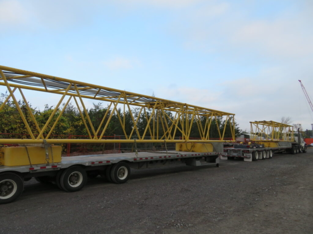 Boom sections on the trucks for removal from site