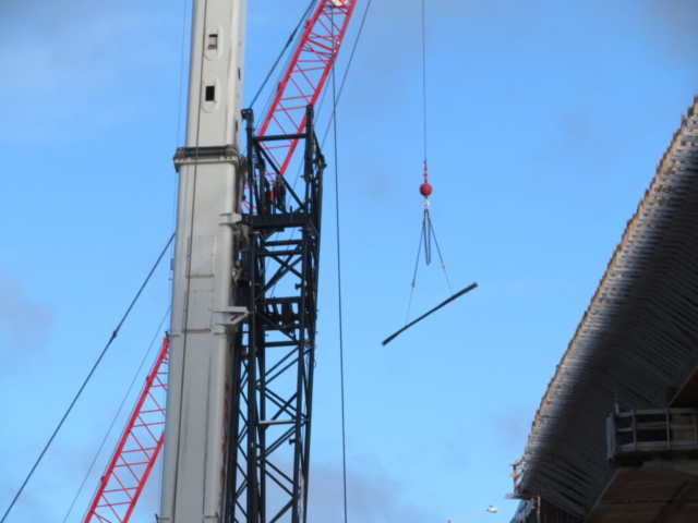 110-ton crane lifting rebar to the deck