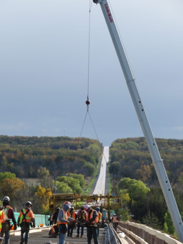 160-ton crane lifting the concrete finisher to the deck