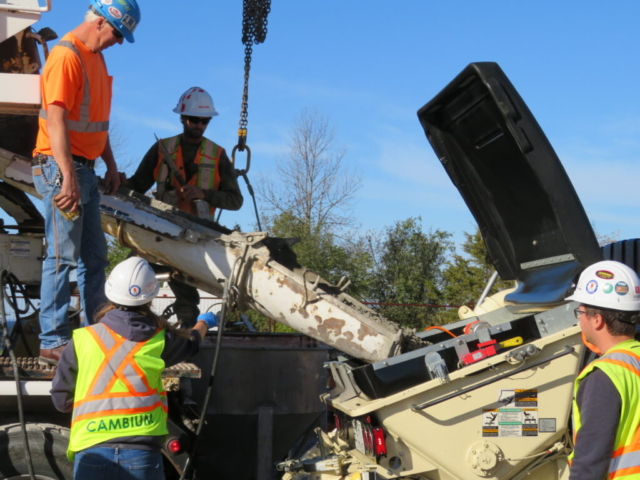 Concrete truck filling the concrete pump