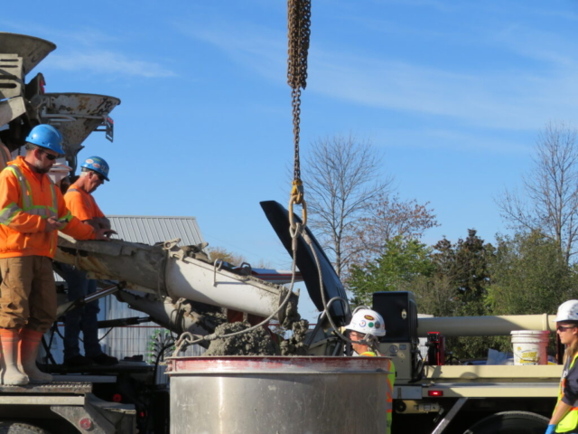 Concrete truck releasing concrete into the hopper