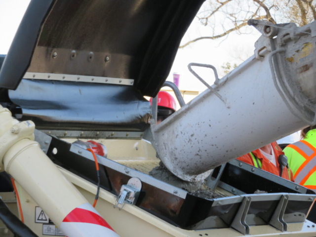 Close-up of the concrete truck filling the pump truck