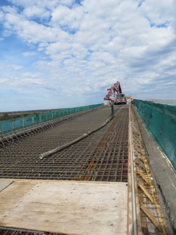 View of the concrete pump preparing for placement on the north end of the deck