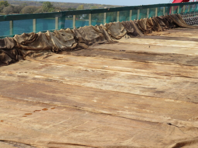 Close-up of completed section of concrete deck covered with wet burlap