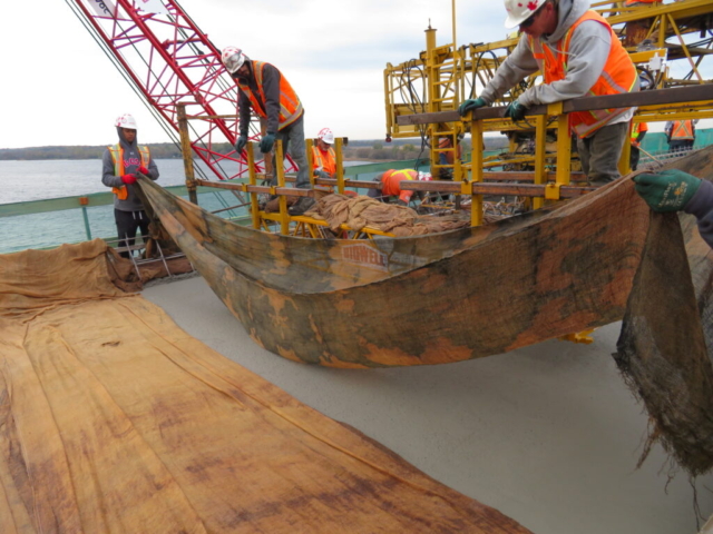 Laying wet burlap on the newly placed concrete