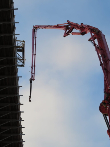 Lifting the concrete pump to the deck for placement