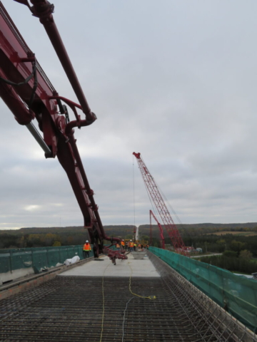 View south of the concrete pump trucks, concrete finisher, 110-ton crane