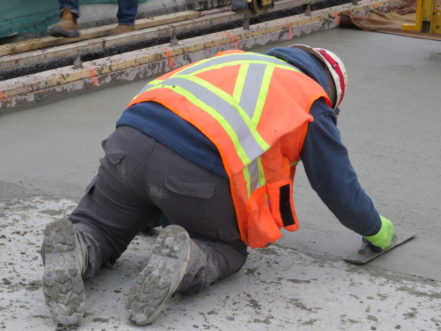 Finishing the edges of the newly placed concrete