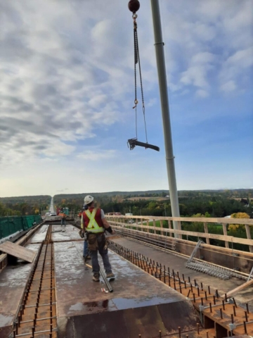 160-ton crane lowering rebar to the bridge deck