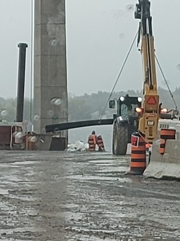 Telehandler moving rebar to be lifted to the deck with the crane