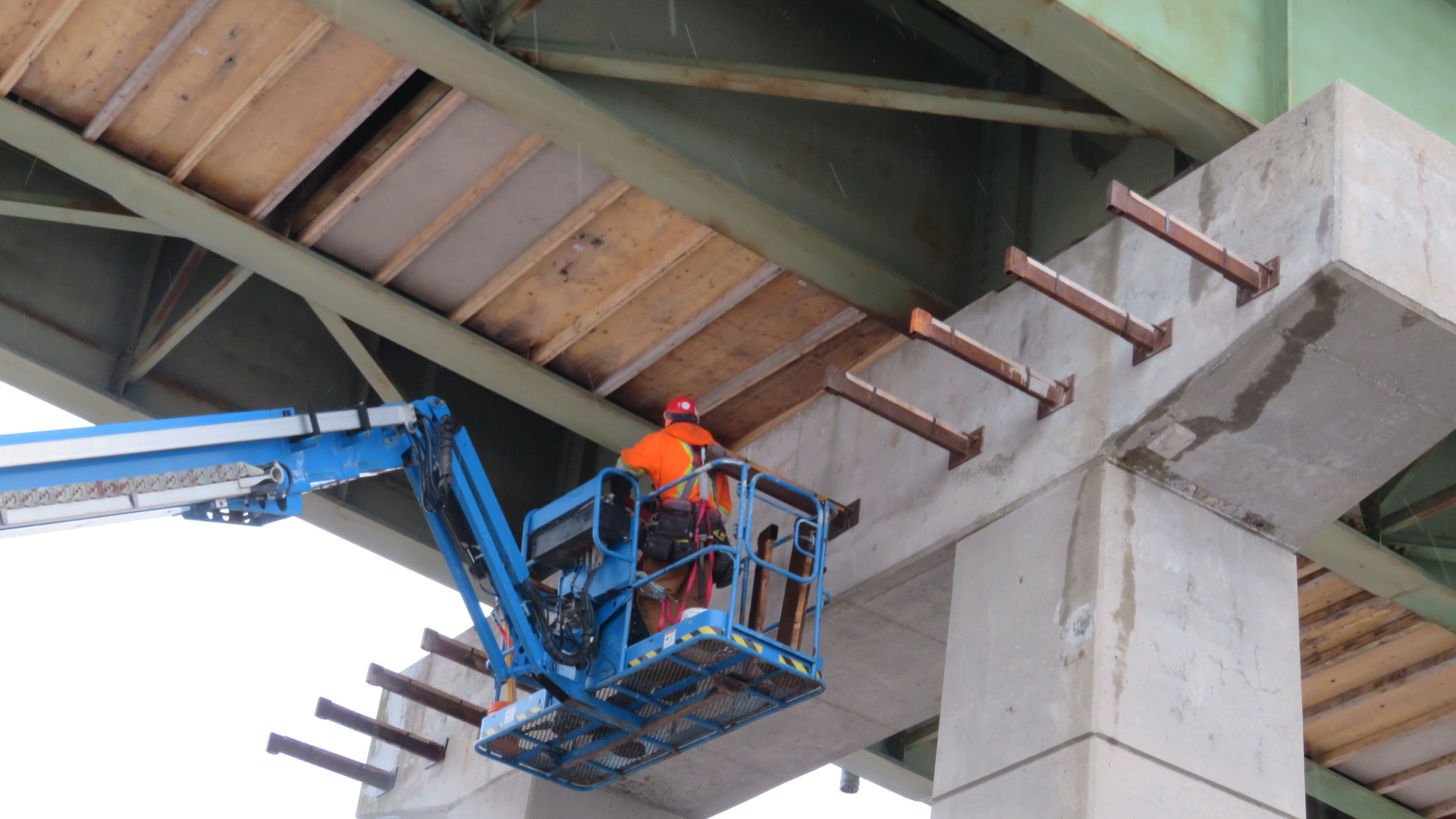 Installing access platform brackets on the north side of pier 16
