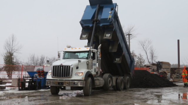Dumping removed asphalt grindings on the project site