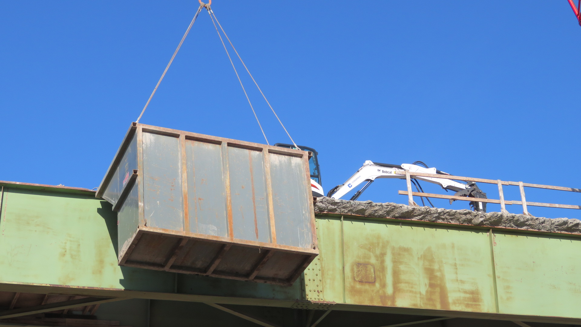 View from below of concrete deck removals, containment bin