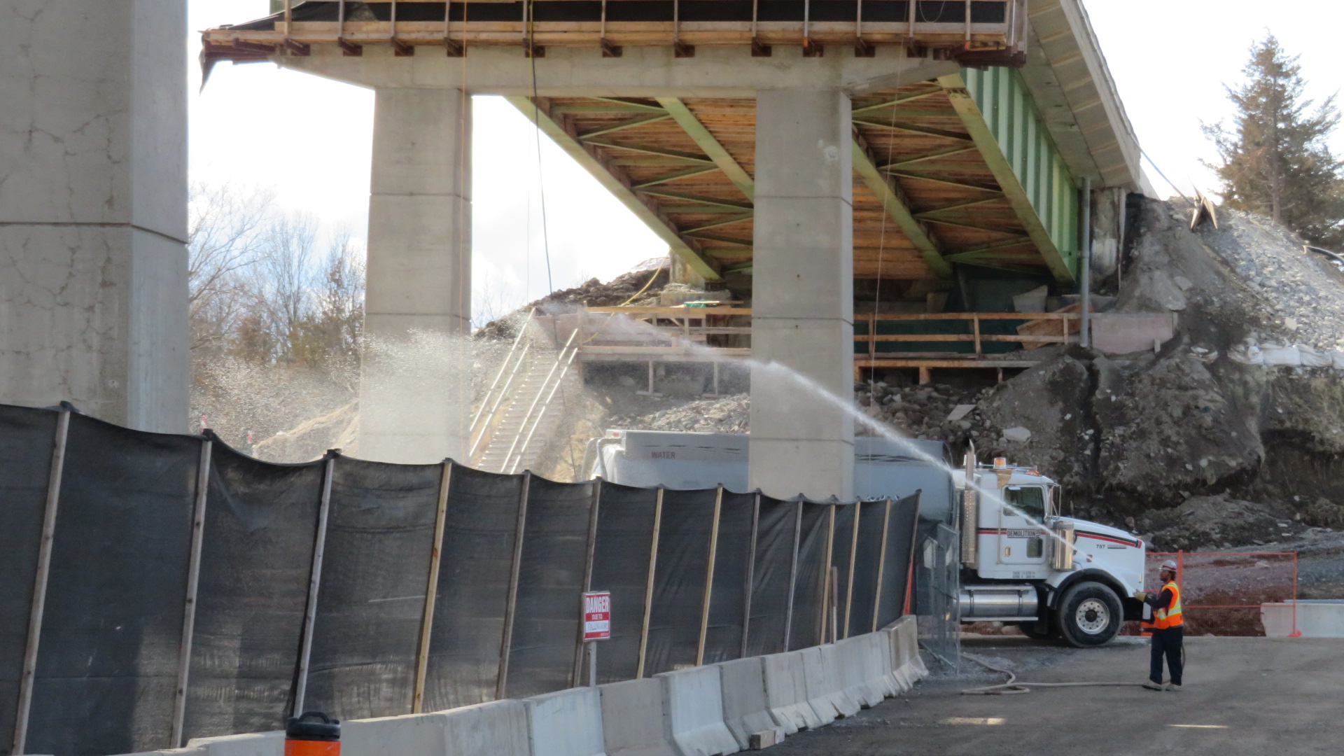 Using water for dust control during concrete deck removal