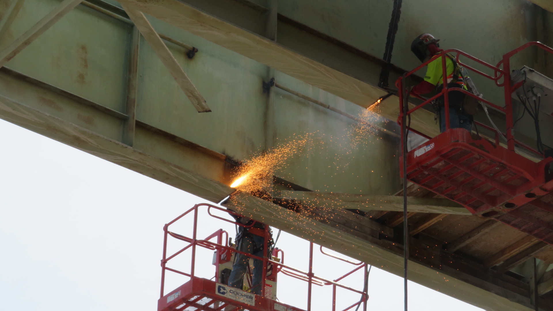 Torch cutting the girder for removal