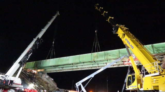 160 and 200 ton cranes, torch cutting both ends of the girder