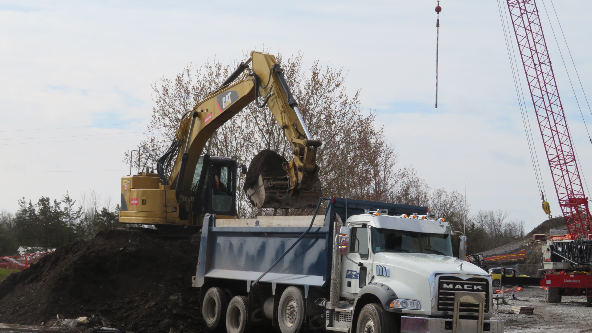 Excavator removing soil to the truck