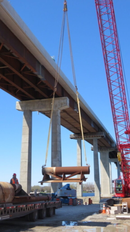Expanded view of 110-ton crane lowering the spudwell onto the truck