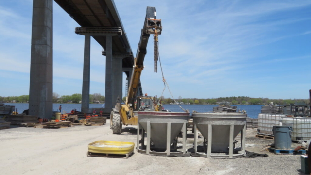 Telehandler, moving concrete hoppers into place for concrete placement on piers 1 & 3
