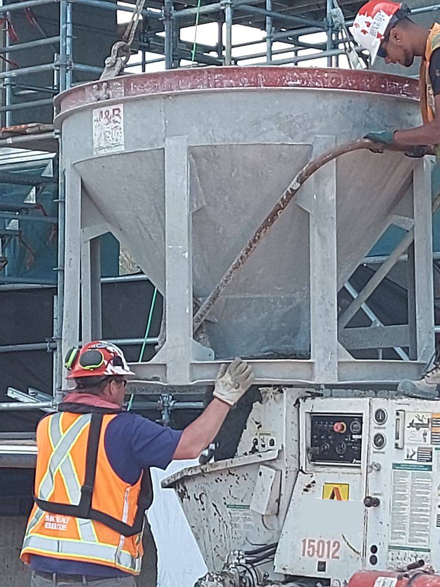 Close-up of concrete being released into the concrete pump