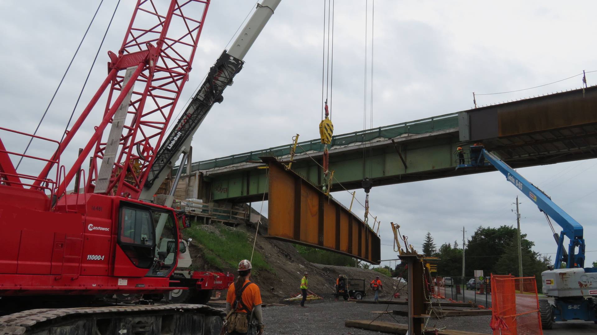 110 and 160-ton cranes lifting the second last girder