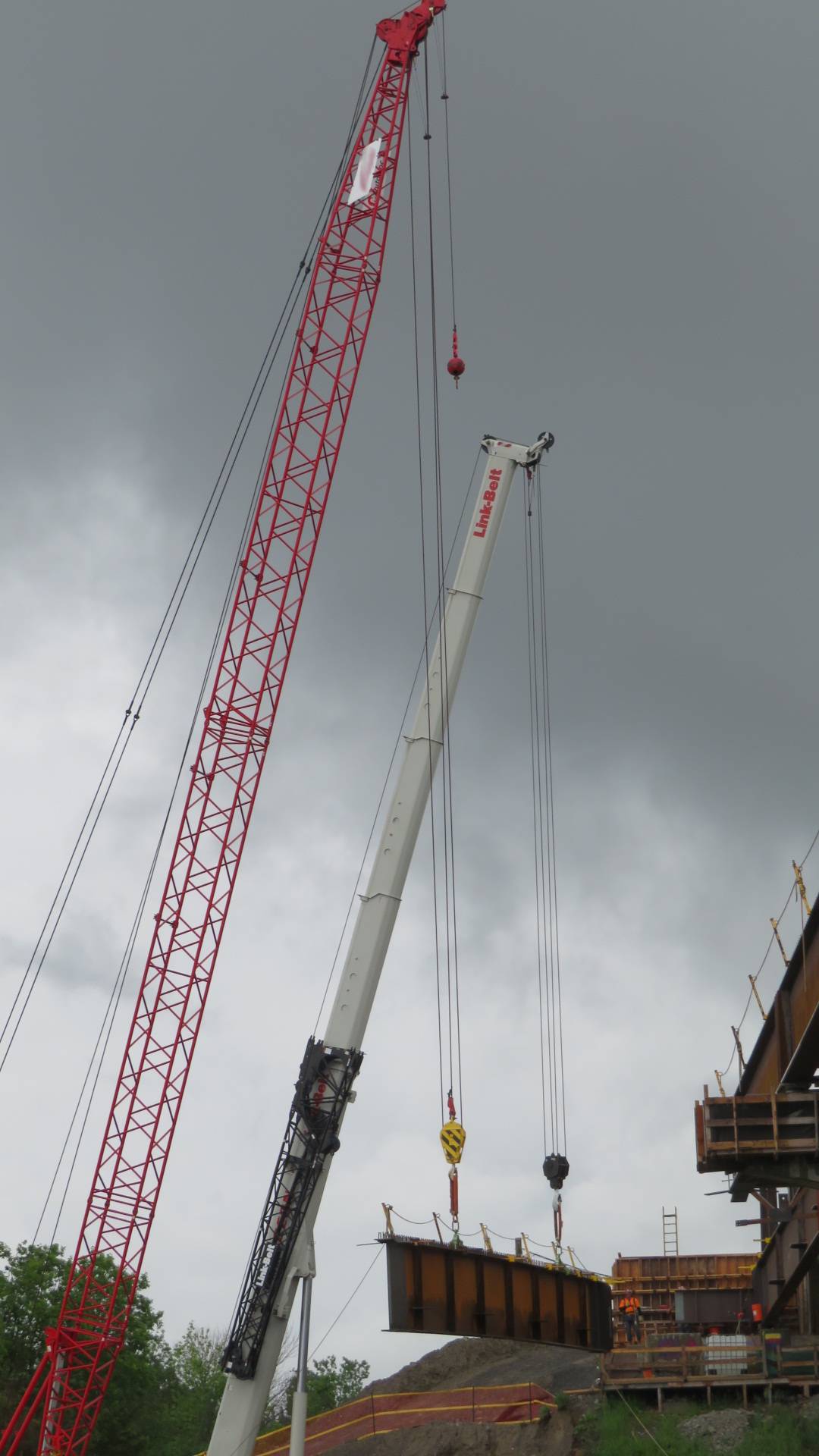 110 and 160-ton cranes lifting the final girder