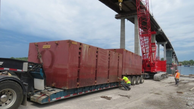 Using the 110-ton crane to load barge sections onto the truck