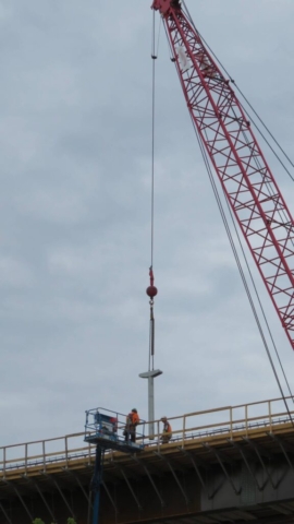 Using the 110-ton crane to lower the deck drain