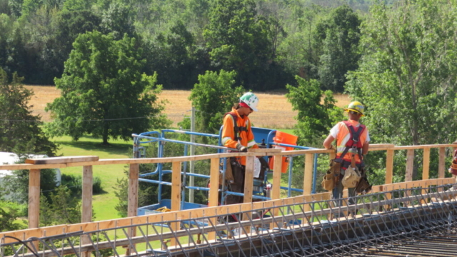 Installing work platform railing and containment netting