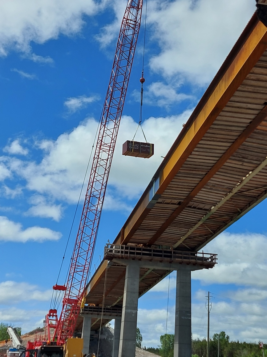 110-ton crane lifting materials to the bridge deck