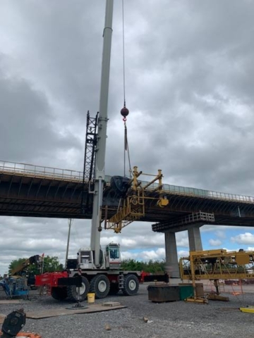 160-ton crane lifting concrete finisher work platform