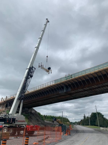 160-ton crane mid-lift, concrete finisher work platform