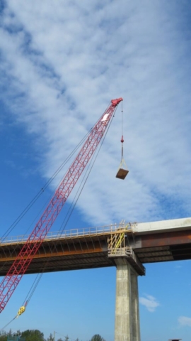 110-ton crane lowering lumber to the deck